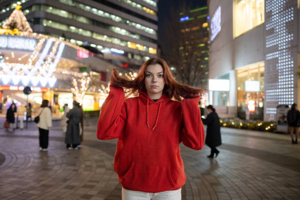 istock Young woman standing in city 1458143576