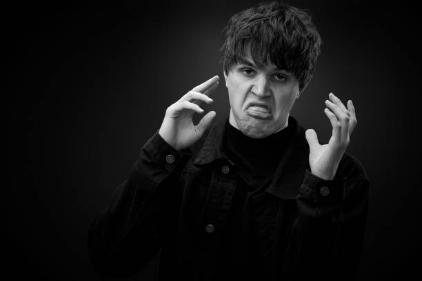 istock crazy young man with awesome hairdo grimacing 1458148187