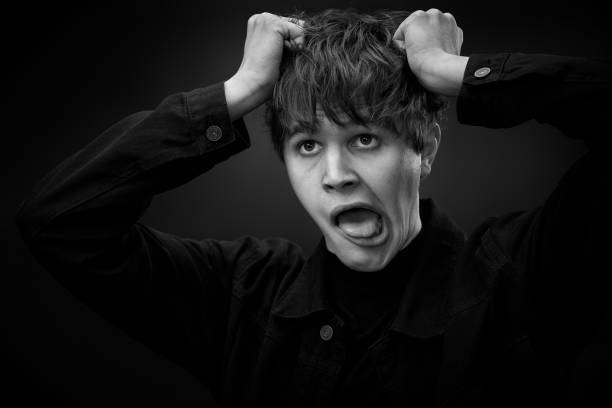 istock crazy young man with awesome hairdo grimacing 1458148206