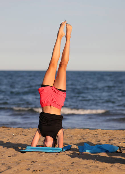 istock young girl stays balanced on the gym mat while doing exercises 1458149297