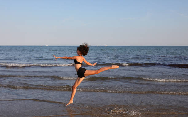 istock young slim athletic girl performs gymnastic exercises in summer 1458150744