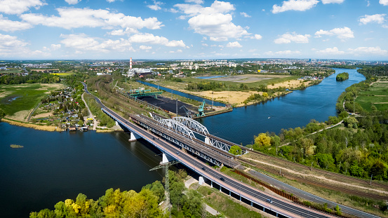 Road and rail bridges on the Oder River. Conventional power plant in the distance, Szczecin, Poland
