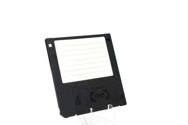 Photo of The image shows a black retro floppy disk with a capacity of 1.44 megabytes (megabytes) on a white background.