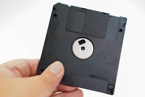 Photo of The image shows a detail of the back of a retro floppy disk with a capacity of 1.44 megabytes (megabytes) on a white background.