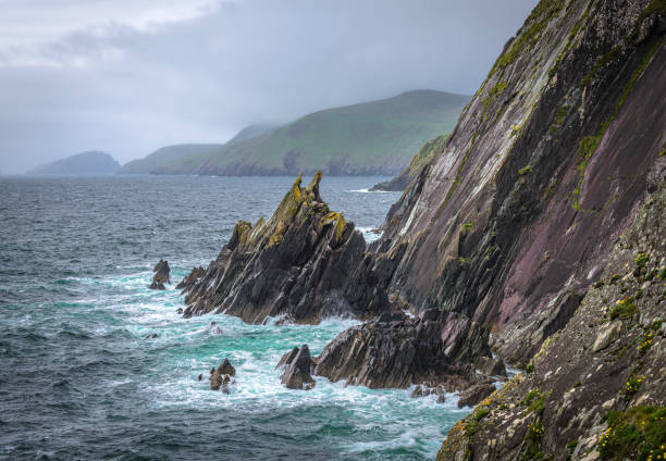 The waves crashing into the cliffs, this is the Dingle Peninsula on Ireland’s Wild Atlantic Way, southwest Atlantic coast.