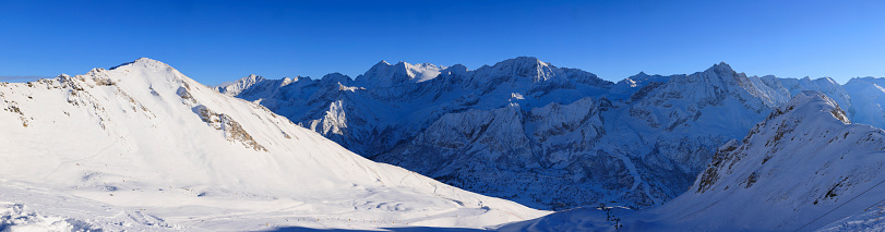 Panoramic High mountain winter landscape  Powder snow at the top. Italian Alps  ski area. Ski resort PASSO TONALE. Italy, Europe.