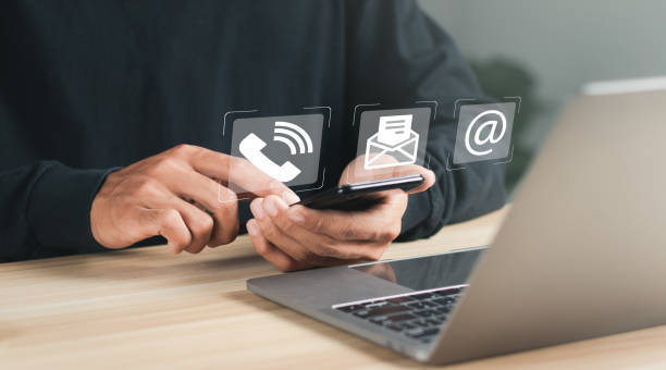 Businessman using laptop and smartphone with contact icons on virtual screen. searching web, browsing information, Contact us or Customer support hotline people connect. Businessman using laptop and smartphone with contact icons on virtual screen. searching web, browsing information, Contact us or Customer support hotline people connect. prop stock pictures, royalty-free photos & images