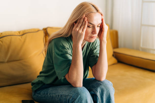 istock The woman suffers from a headache. Problems and stress affect a person. 1458167932