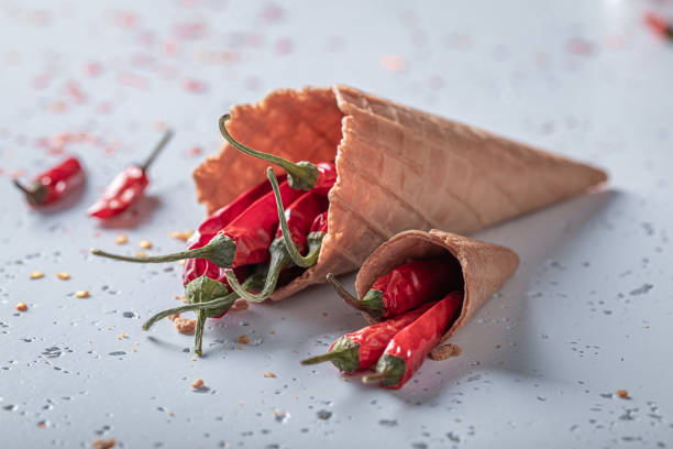istock Chilli peppers in ice cream cone. Spicy ice cream concept. 1458171041