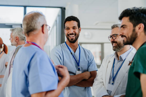 Team of doctors discussing something at hospital corridor. stock photo