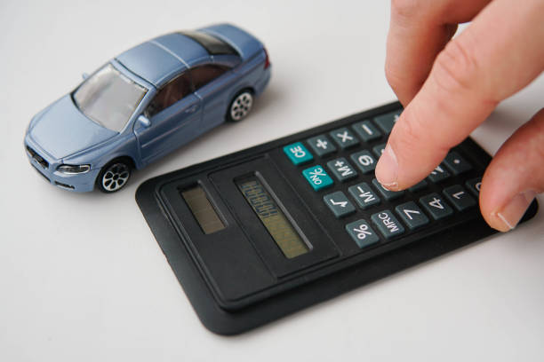 istock Man using calculator for buying a car. Car rental, purchase or insurance. 1458180923