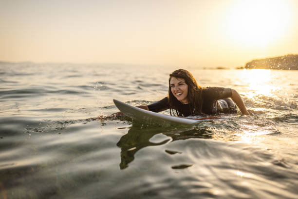 istock Surfer woman puddle on surfboard 1458184065