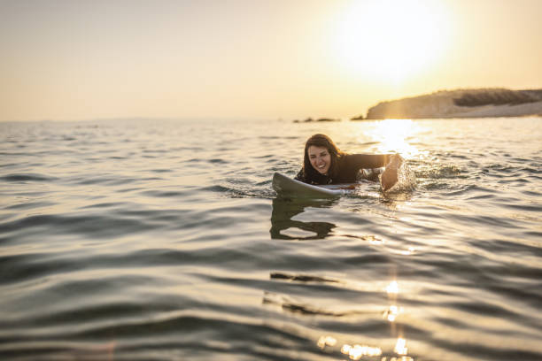istock Surfer woman puddle on surfboard 1458188048
