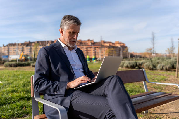 istock Concentrated senior businessman working on laptop 1458188150