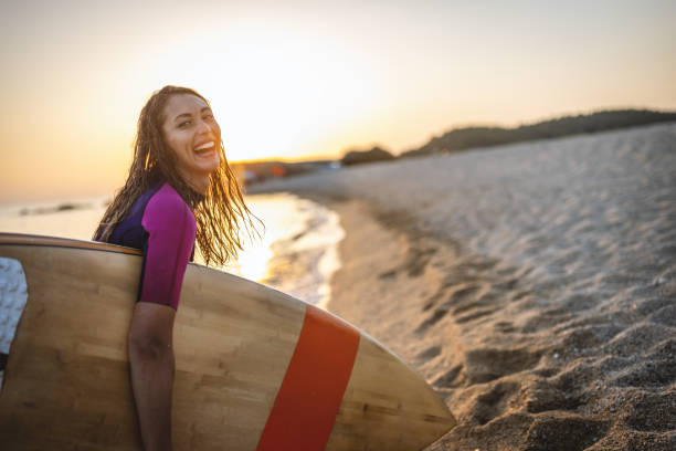 istock Surfer woman at the beach 1458188573