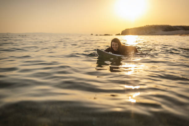 istock Surfer woman puddle on surfboard 1458188723