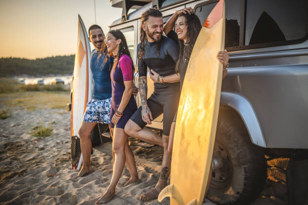 istock Friends preparing for surfing by the car 1458188862