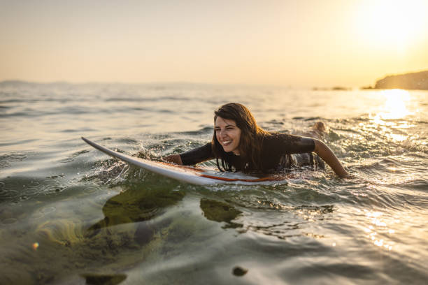 istock Surfer woman puddle on surfboard 1458189155