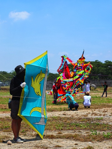 Surabaya, Indonesia - October 02, 2022 : the team is preparing kites at the surabaya kite festival