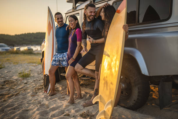 istock Friends preparing for surfing by the car 1458190887