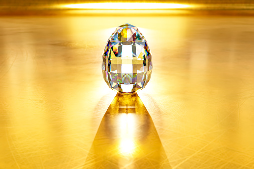 A stunning diamond easter egg is rendered in 3D on a golden backdrop.