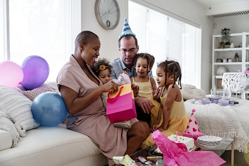 Multi-ethnic family celebrating 1 year old baby girl, canada
