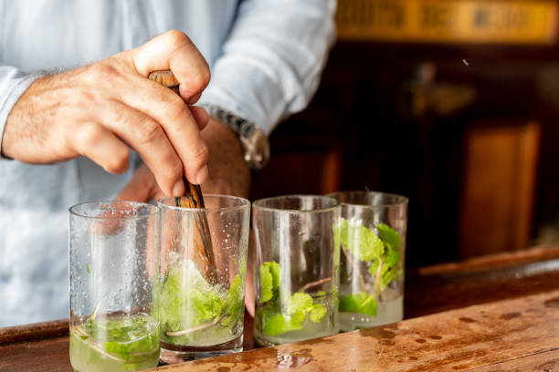 istock A skilled bartender expertly prepares a traditional Cuban mojito cocktail, complete with mint leaves and lime wedges. 1458193850