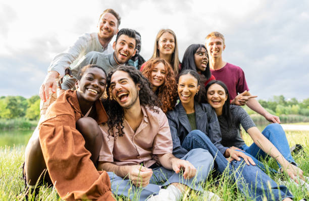 istock Multiracial group of students laughing together outside at park - Integration, diversity, and  university concept. 1458194463