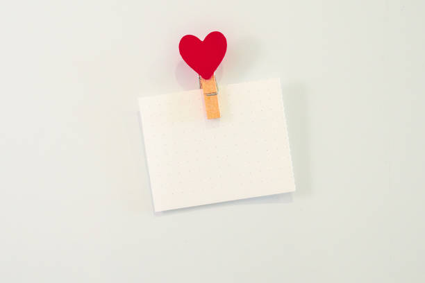 istock Empty white sheet of paper with heart-shaped magnet on the fridge. 1458195744