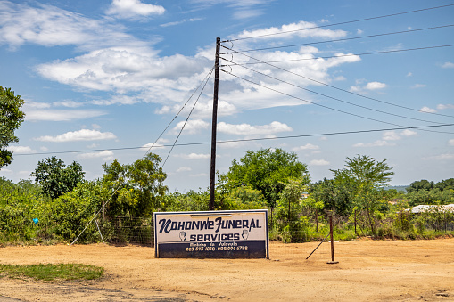 Kruger Park area, South Africa - December 3th 2022: Undertakers advertisement poster along the highway outside the Kruger National Park in South Africa