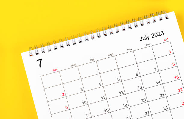 The July 2023 Monthly desk calendar for 2023 year on yellow background. stock photo