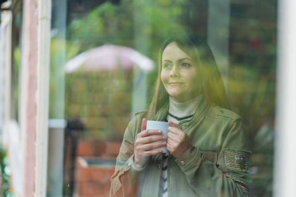 istock Therapist enjoys her cup of coffee while looking out the window 1458206566
