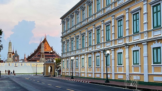 Bangkok, Thailand - November 17, 2022 : The Side Facade of The Ministry of Defence Headquarters with The Temple of the Emerald Buddha.