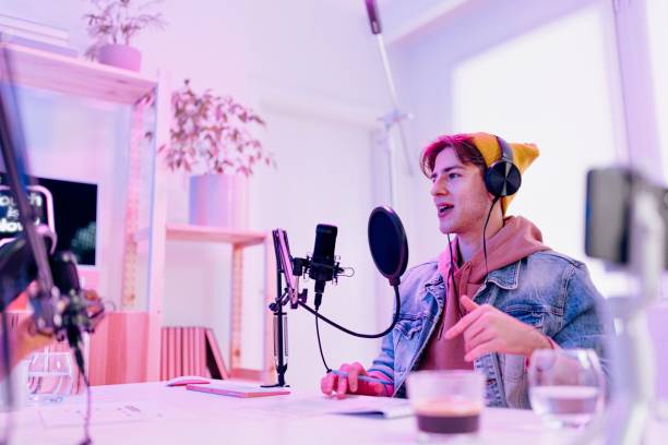 istock Young man recording podcast 1458213293