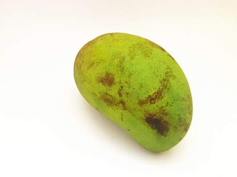 A fresh green mango fruit on a white background