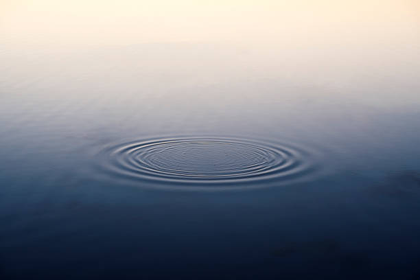 Rings in the water Expanding ripples forming a ring in water still water stock pictures, royalty-free photos & images