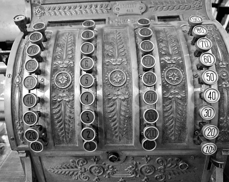 evocative black and white close-up image of old retail cash register