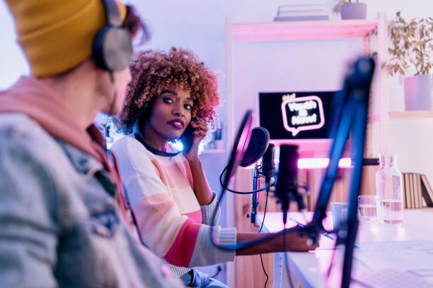 istock Two people record podcast episode in home studio 1458213958