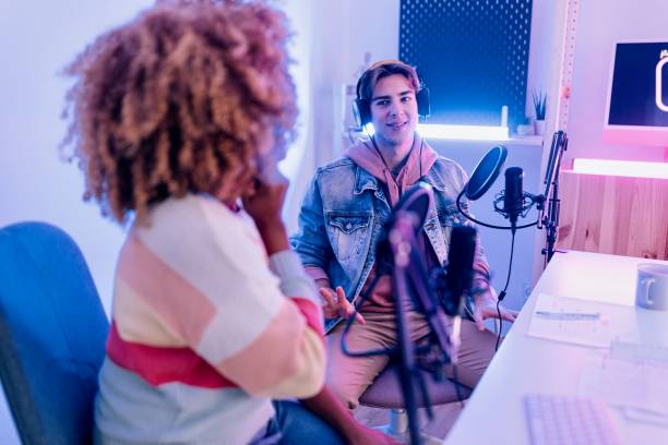 istock Diverse colleagues recording podcast and talking in microphones 1458214035