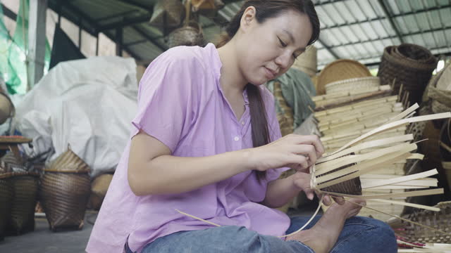 Woman learn weaving bamboo basket, handmade by Villagers from Chiangmai, Thailand.