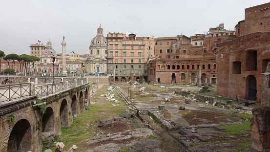 A suggestive and detailed image of the Roman Forum taken from the terrace of the Campidoglio (Roman Capitol) on the Capitoline Hill, in the heart of the historic center of the Eternal City. The Roman Forum, one of the largest archaeological areas in the world, represented the political, legal, religious and economic center of the city of Rome, as well as the nerve center of the entire Roman civilization. In the foreground the Forum of Caesar with the remains of the Temple of Venus Genetrix, while in the background the Forum of Trajan. In the center the Fori Imperiali Boulevard, which connects the Colosseum with the central square of Piazza Venezia.. In 1980 the historic center of Rome was declared a World Heritage Site by Unesco. Image high definition format.