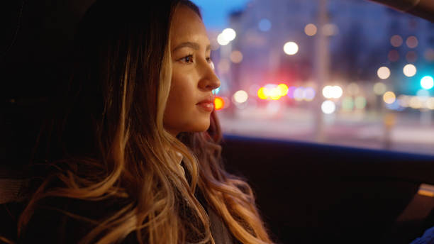 istock Woman driving a car at night 1458215564