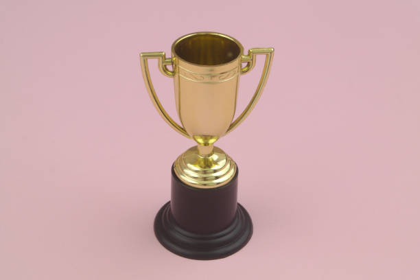 istock Champion golden trophy cup on pink 1458215911