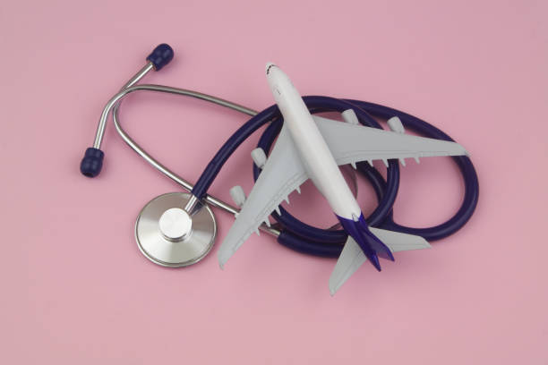 istock Airplane model and stethoscope on pink background 1458215958