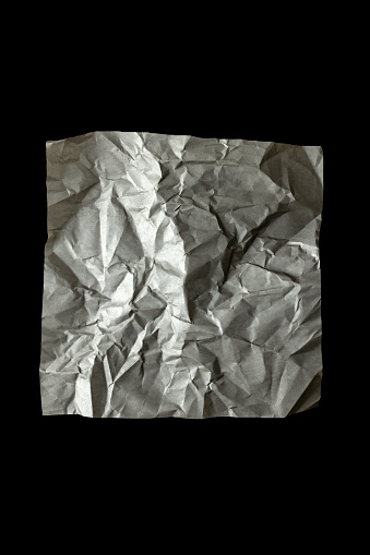 Crumpled paper towels on the black granite background with copy space