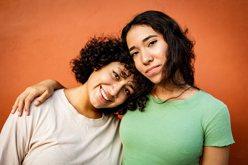 Portrait of two happy young woman looking at the camera