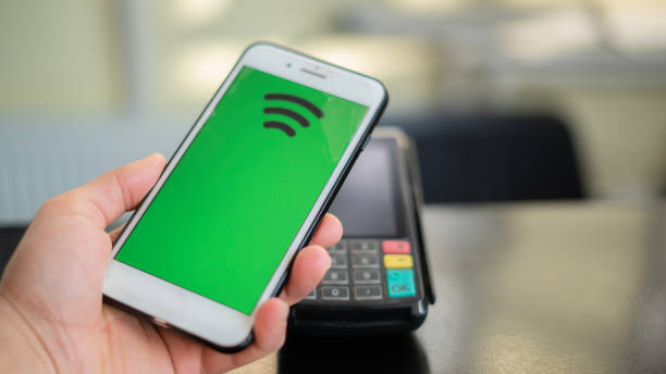 istock Close-up Customer making contactless payments by phone , mock up screen 1458221709