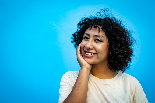 Young Hispanic woman looking at the camera and smiling