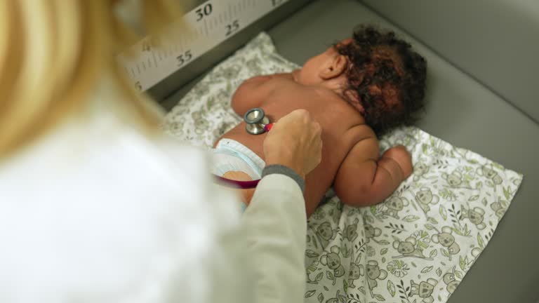 Pediatrician examining baby