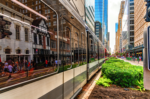 Houston, United States - November 22, 2022:  The Houston light-rail train known as METRORail traveling down Main Street in downtown Houston, Texas.